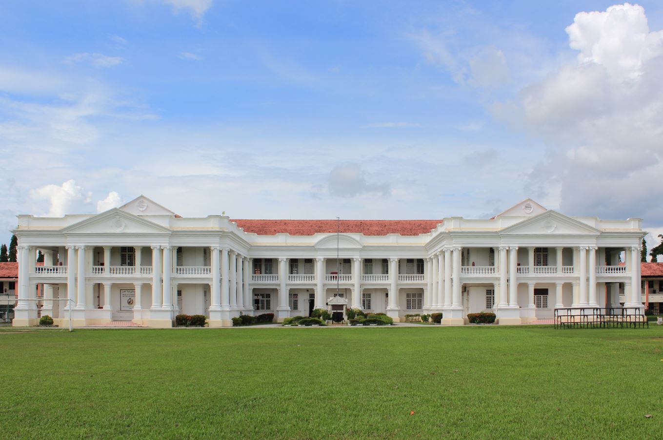 马来学院（MCKK）江沙校园的 Big School 主楼。这所殖民时期专为马来贵族子弟设立的精英寄宿学校，是敦拉萨成长道路上两段截然不同教育经历中的第二段——从亚答屋顶的乡村小学，走到这里宽廊长廊的精英校园。